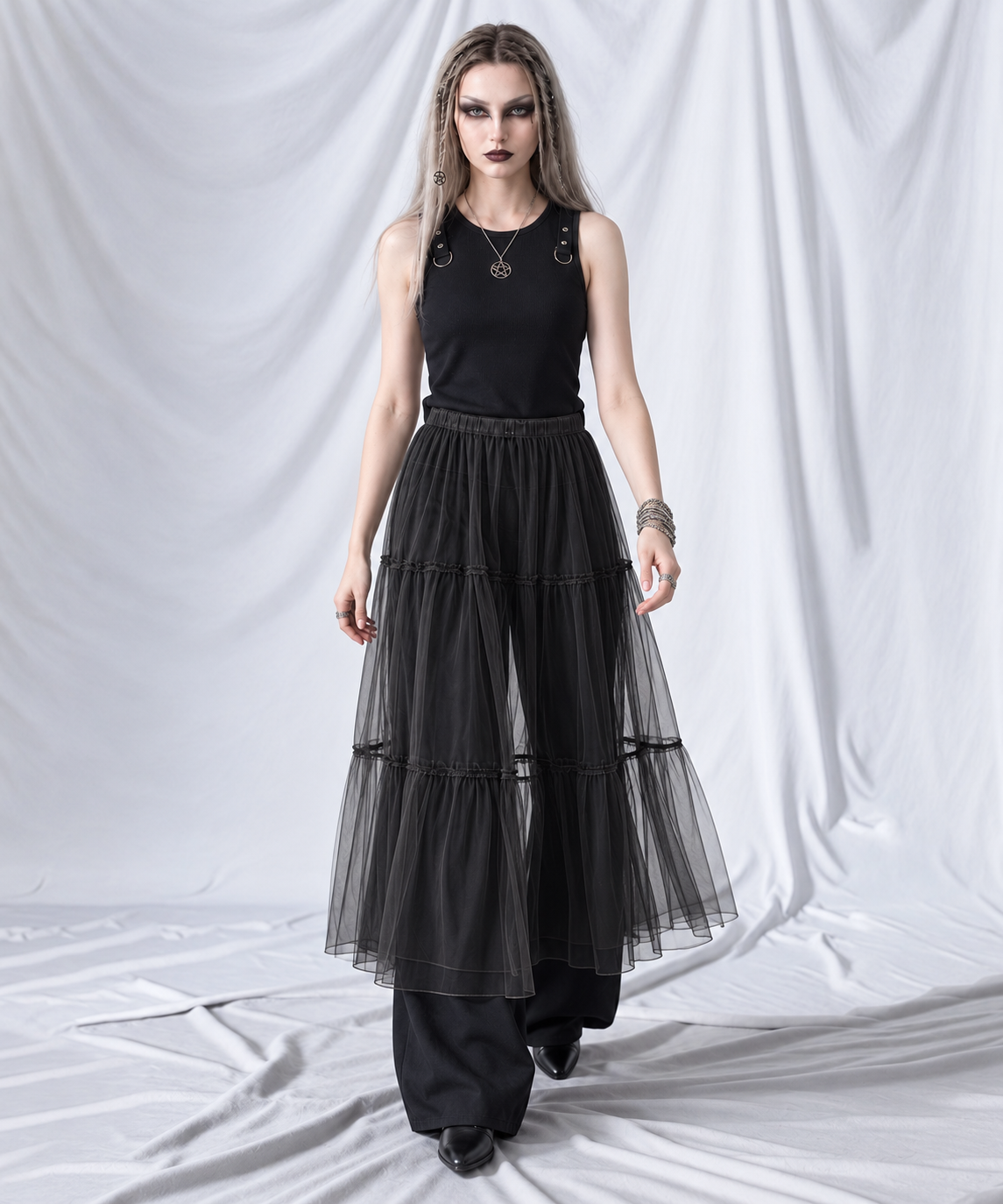 Black layered gauze overlay midi skirt in a walking pose, showing the airy tiered silhouette.