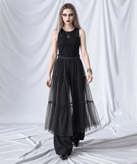 Black layered gauze overlay midi skirt in a walking pose, showing the airy tiered silhouette.