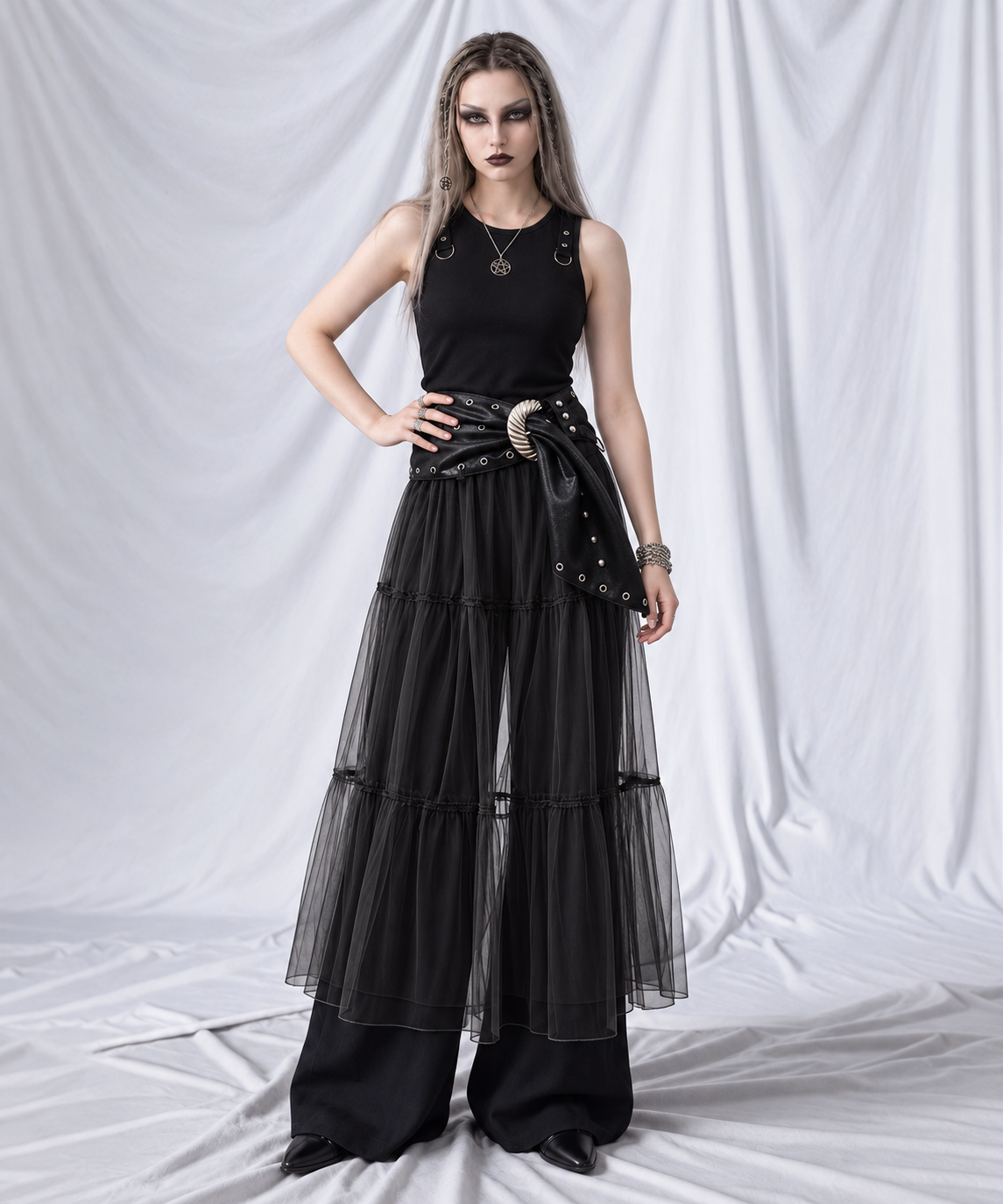 Black layered gauze overlay midi skirt styled with a wide black wrap belt and sculpted silver buckle.