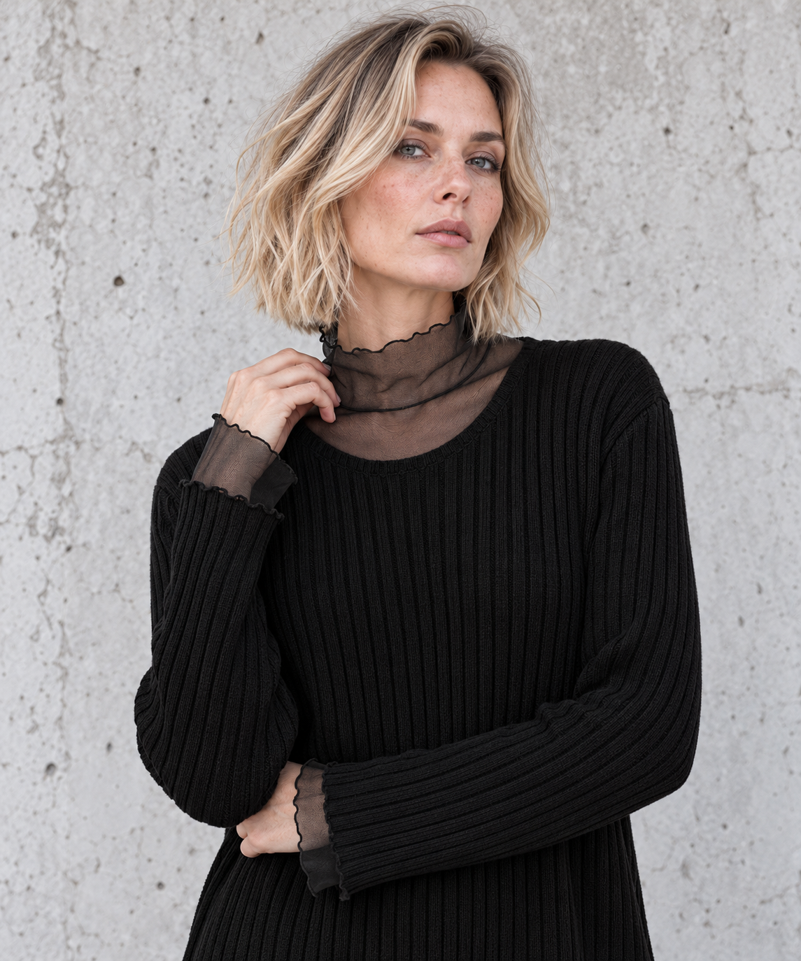 Close-up of black sweater sheer mesh high collar, scoop neckline and vertical rib knit – Simple Moderne