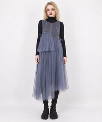 Dusty blue-violet mesh asymmetric midi dress, full-length front view styled over a black turtleneck and slip.