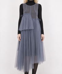 Blue-violet mesh dress detail showing the side ties, fine pleats, sheer skirt and asymmetric hem.