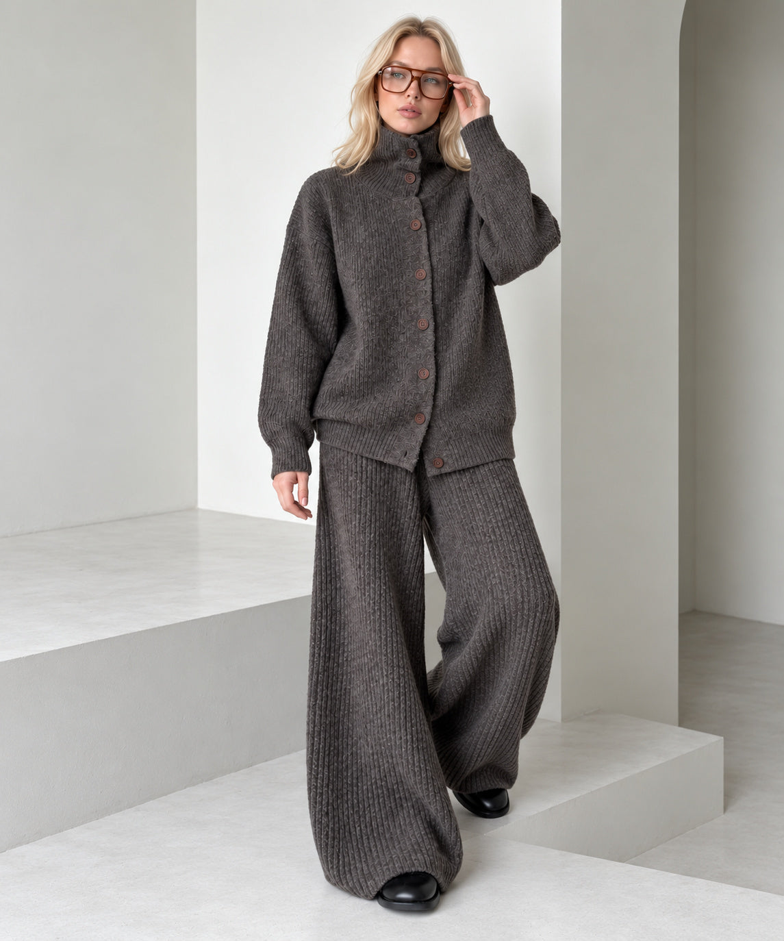 Coffee brown knitted cardigan and wide-leg trousers set, full-length stepping pose showing the loose trouser drape.