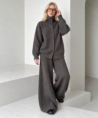 Coffee brown knitted cardigan and wide-leg trousers set, full-length stepping pose showing the loose trouser drape.