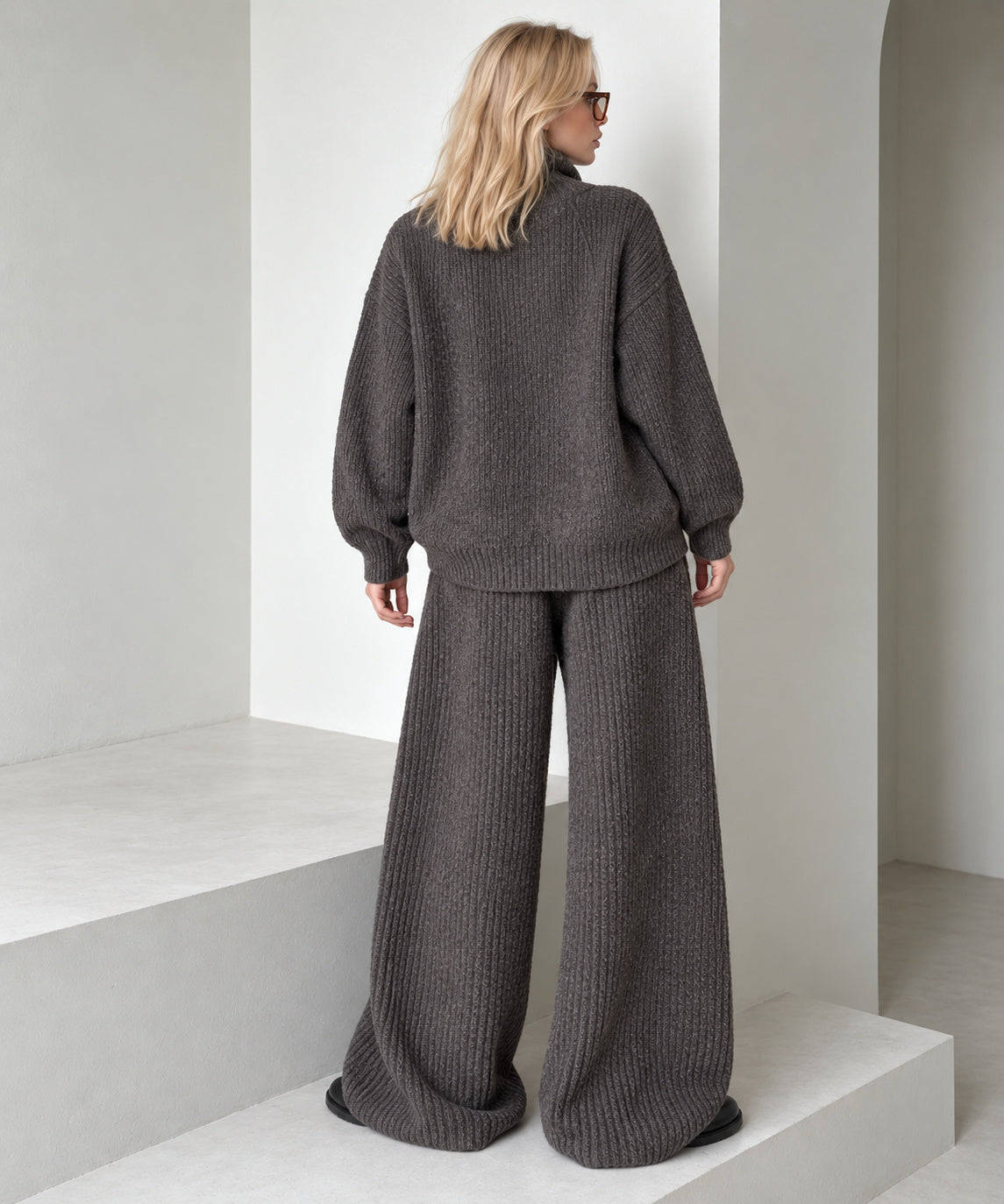 Back view of the coffee brown knitted cardigan and wide-leg trousers set, showing the dropped shoulders and loose silhouette.
