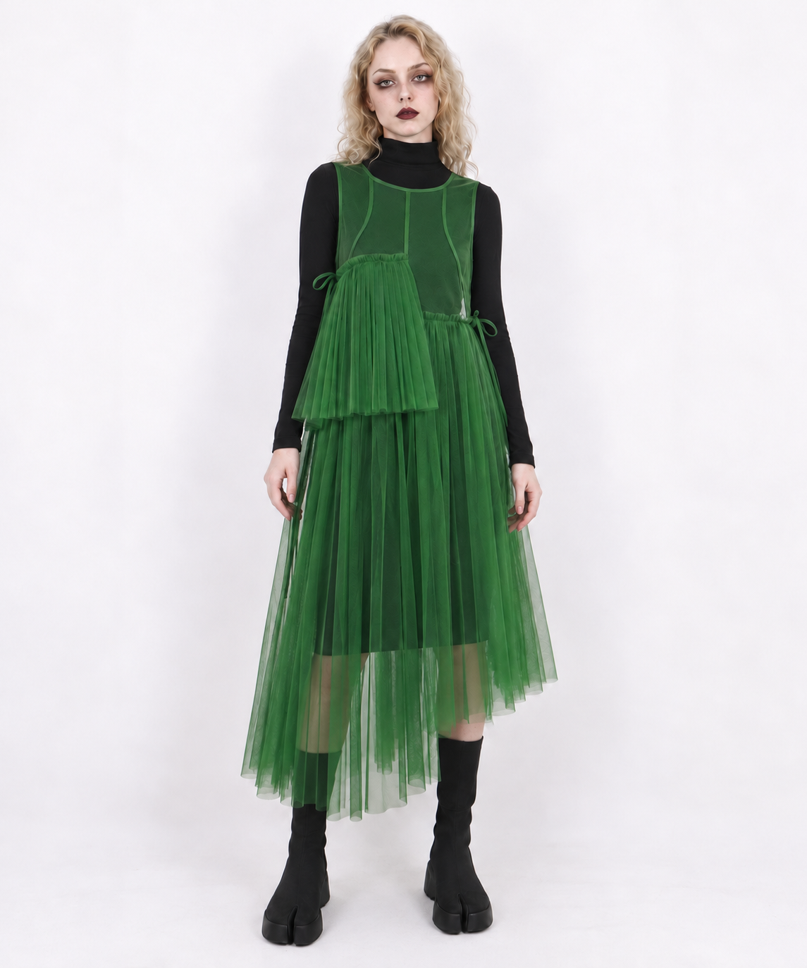Green mesh asymmetric layered midi dress, full-length front view styled over black layers with split-toe boots.