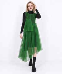 Green mesh asymmetric layered midi dress in a relaxed walking pose, showing the sheer skirt and uneven hem.