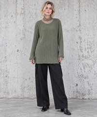 Olive Green Oversized Turtleneck Knit Sweater. Full-length front view on a blonde model, showing the olive ribbed knit, long relaxed silhouette and sheer neckline.