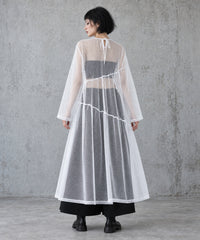 Back view of the white layered gauze maxi dress showing the tie neckline opening and diagonal tier seams.