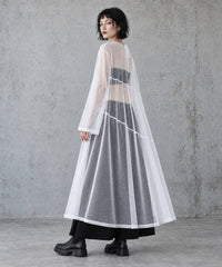 Rear three-quarter view of the white sheer A-line maxi dress showing the long sleeves and loose drape.