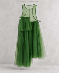 Green mesh asymmetric layered midi dress displayed flat against a light concrete background.